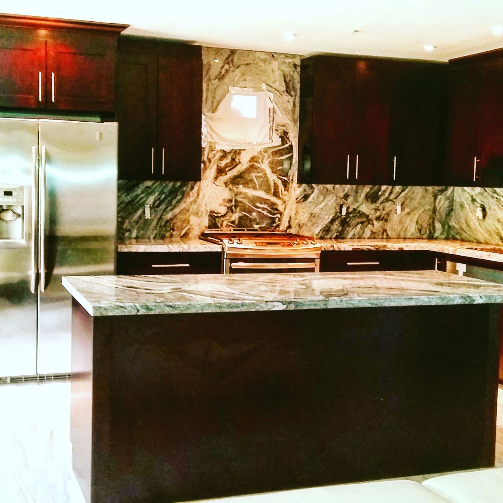 Gray granite countertops with full-height backsplash
