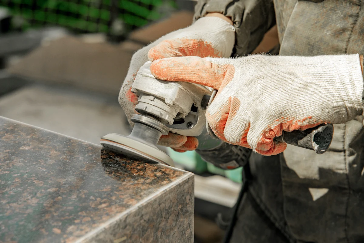 Fabricator polishing a granite countertop edge